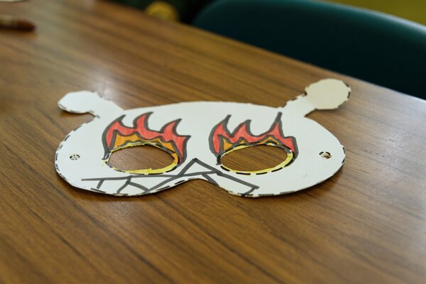 A fiery mask on a desk